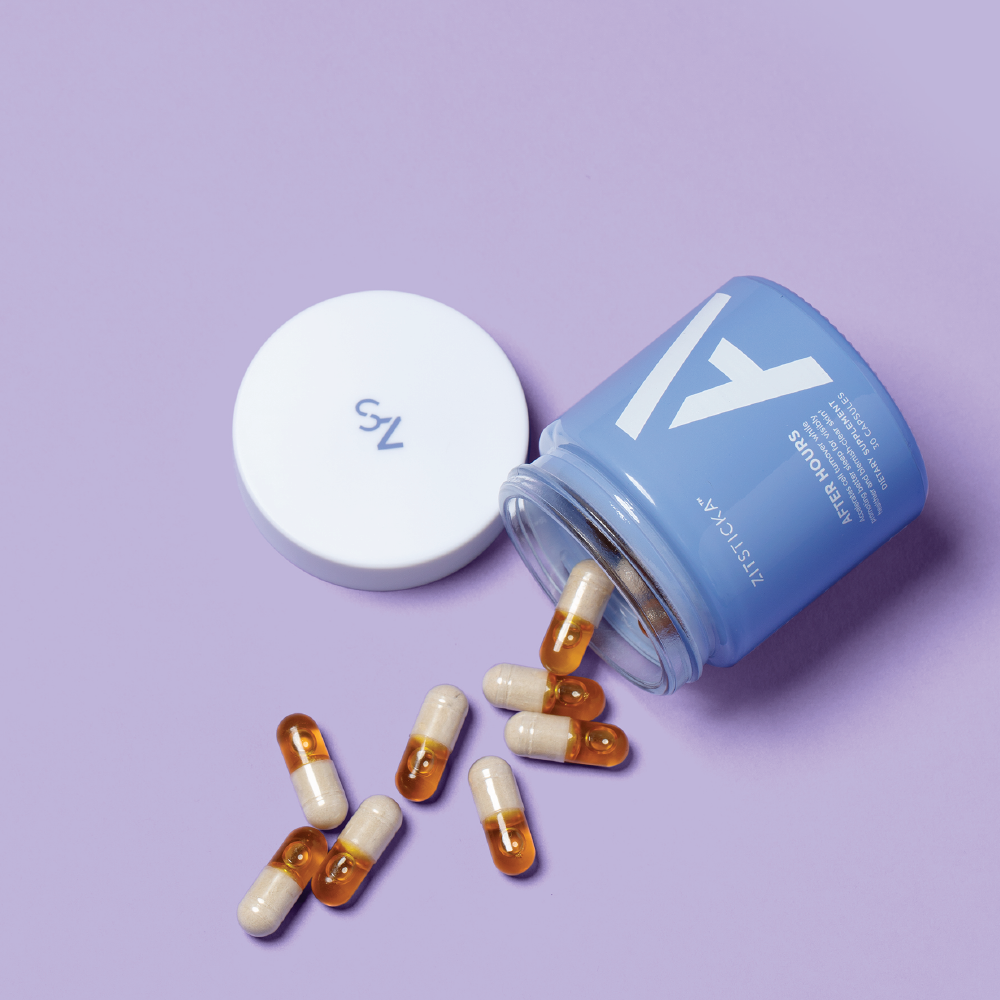 A blue AFTER HOURS jar with a white lid spills capsules for glowing skin on a purple background.
