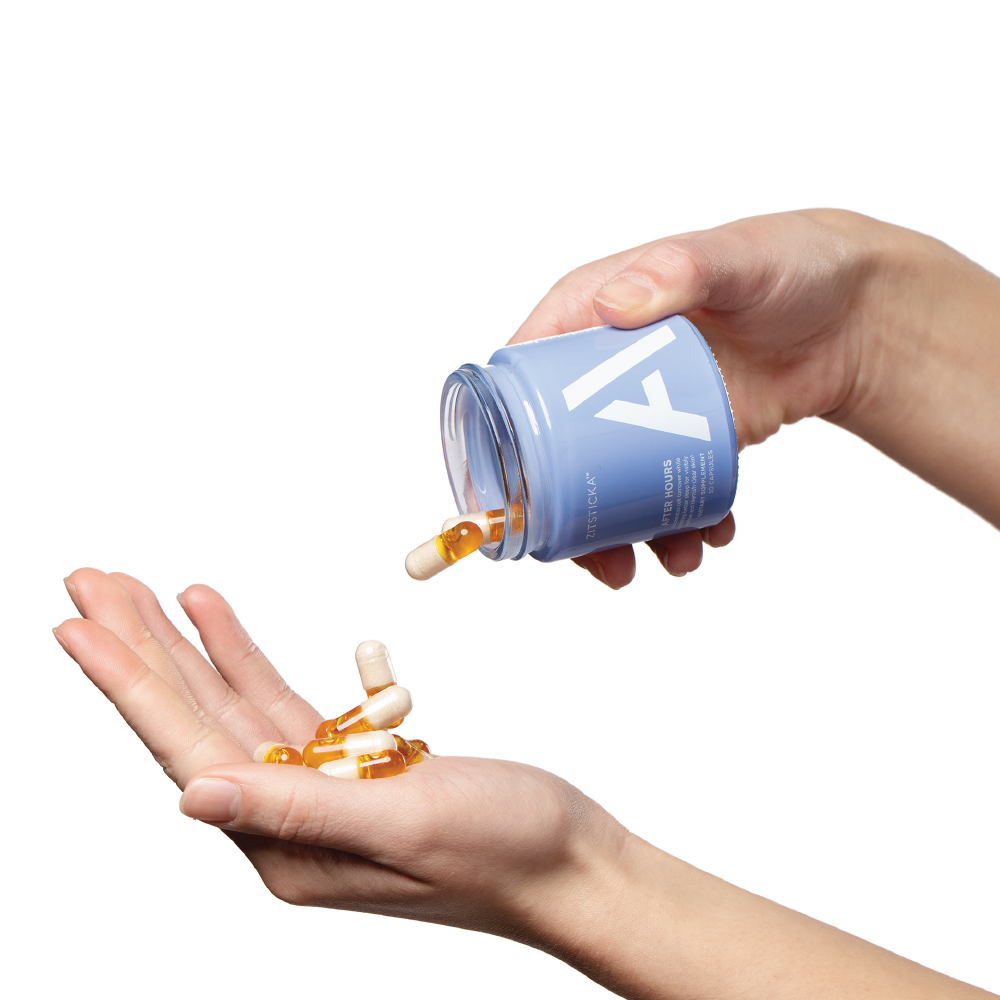 A hand pours AFTER HOURS capsules from a blue bottle, supporting a glowing complexion.
