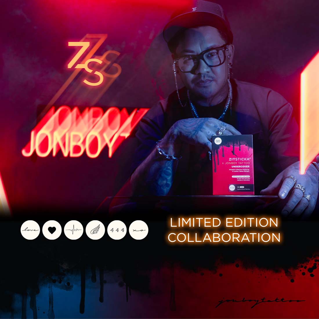 Tattooed man with glasses holds ZitSticka x Jonboy Tattoo Undercover Patches; neon tattoos glow.