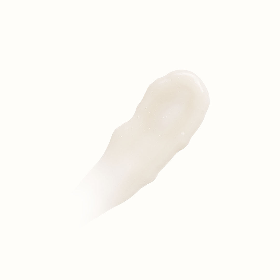 A smear of CUSHION CLEANSE, a white creamy lotion with hydrating acids, on a white background.