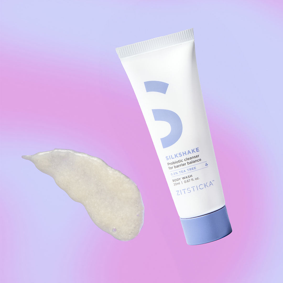 Head-to-toe Clearing Kit tube with product smear on a pink and purple gradient background.
