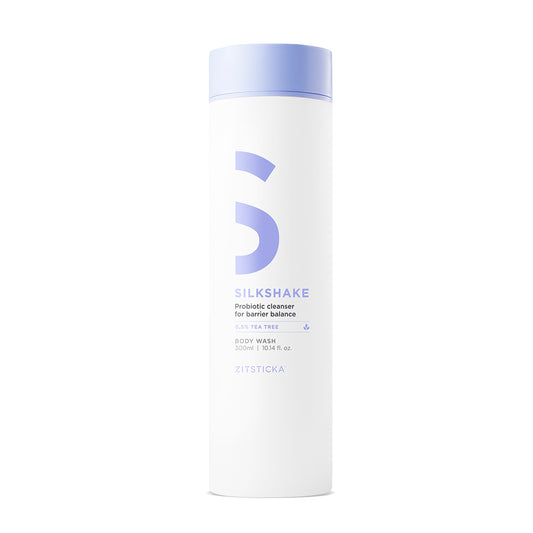 White bottle of SILKSHAKE cleanser with a light purple cap and text.